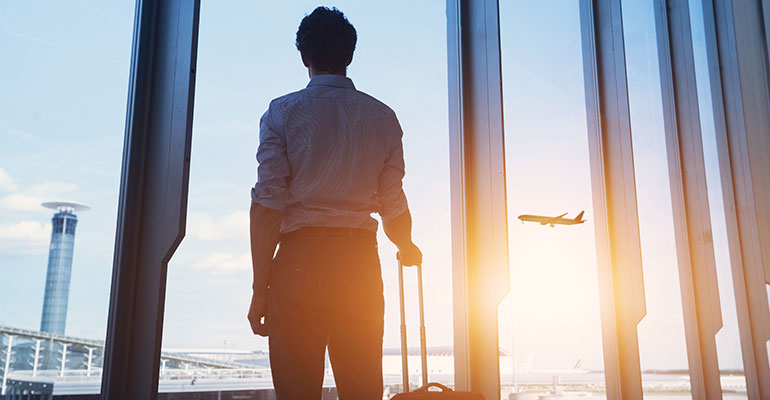 FPI Top 10 | Man staring our of the window at planes and sunset