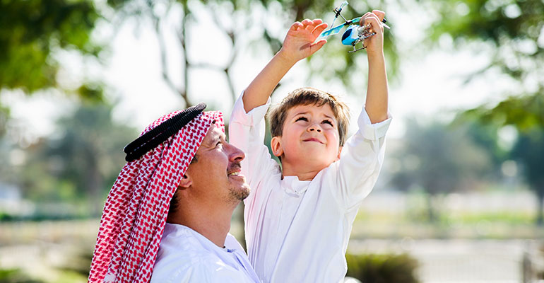 FPI Top 10 | Father and son playing with a toy helicopter in a park