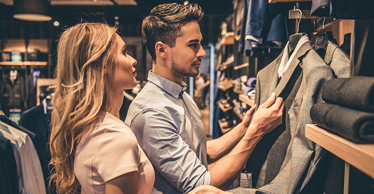 FPI Top 10 |  Man in a shop choosing a suit